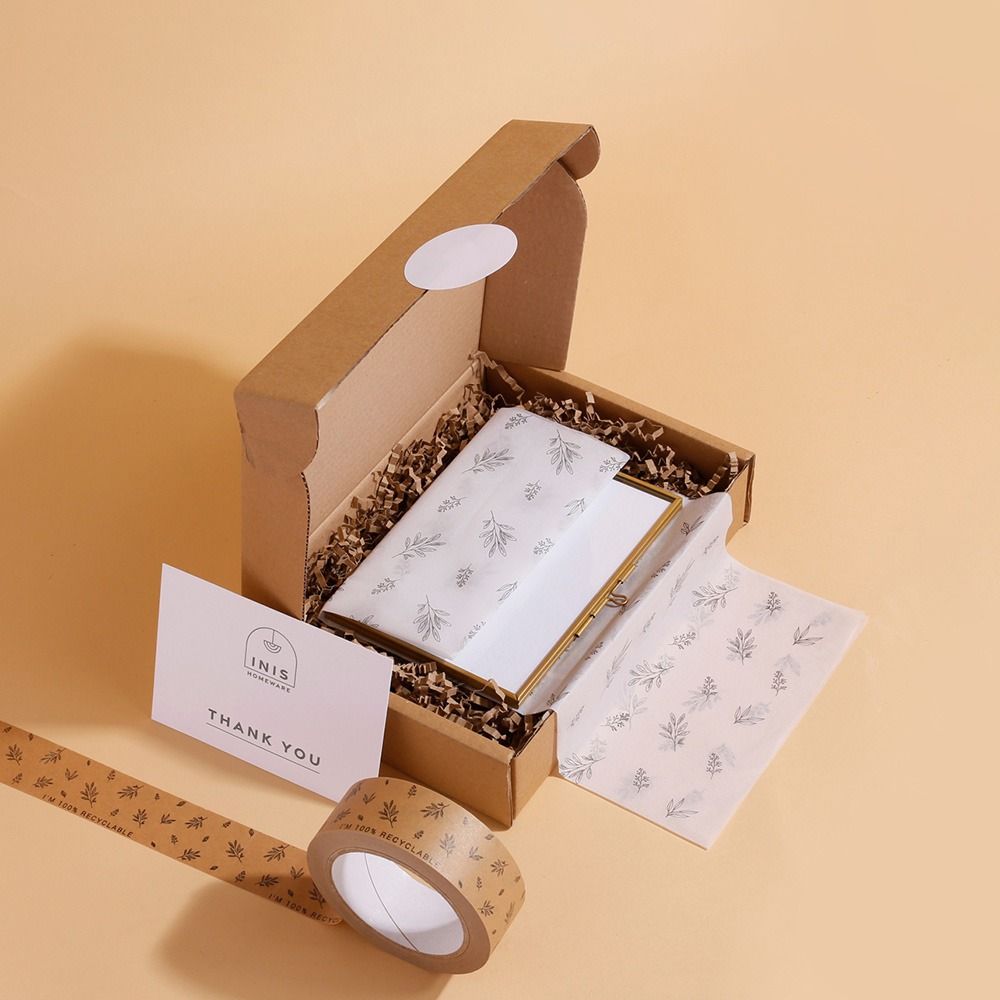 Printed stickers creating a coordinated unboxing experience across boxes, tissue and inserts.