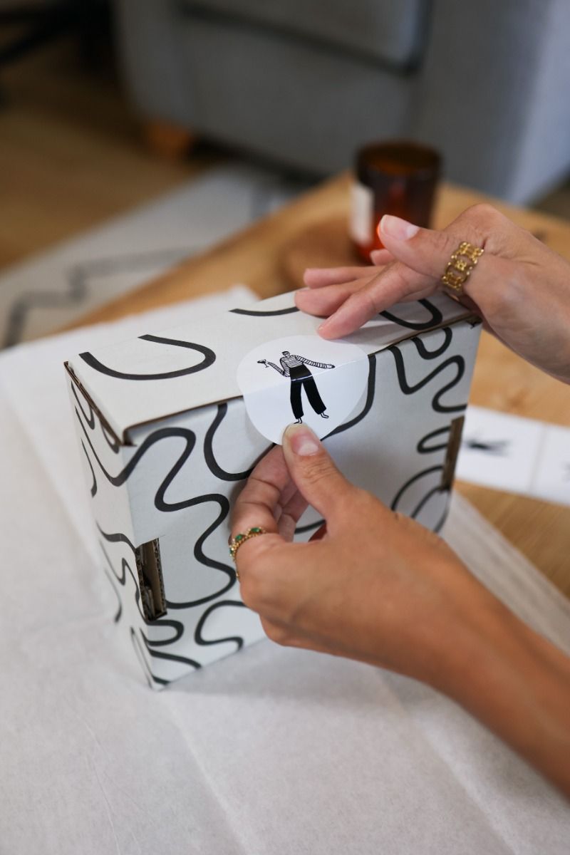 Printed QR code stickers applied to branded packaging ready to scan.