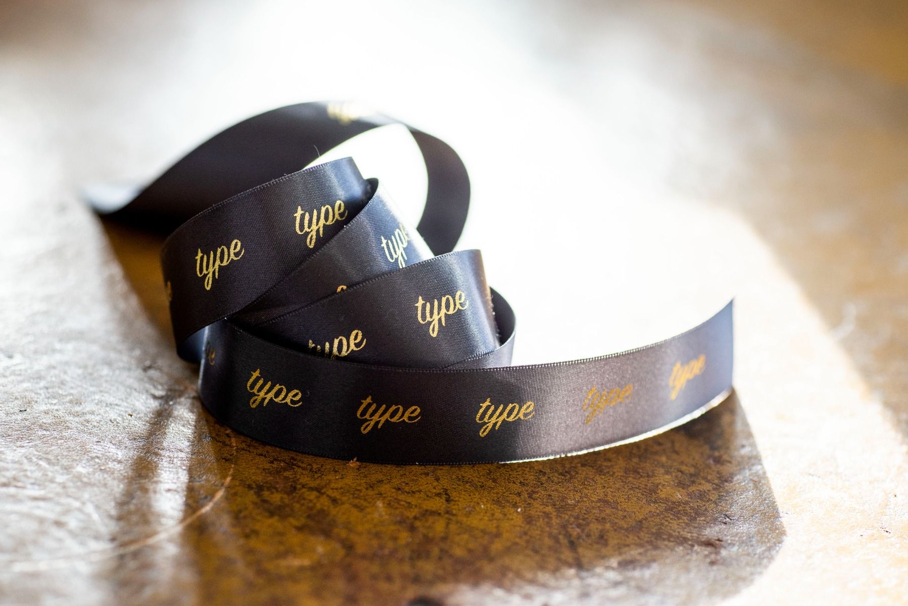 Seasonal branded packaging finished with coordinating custom printed ribbon.