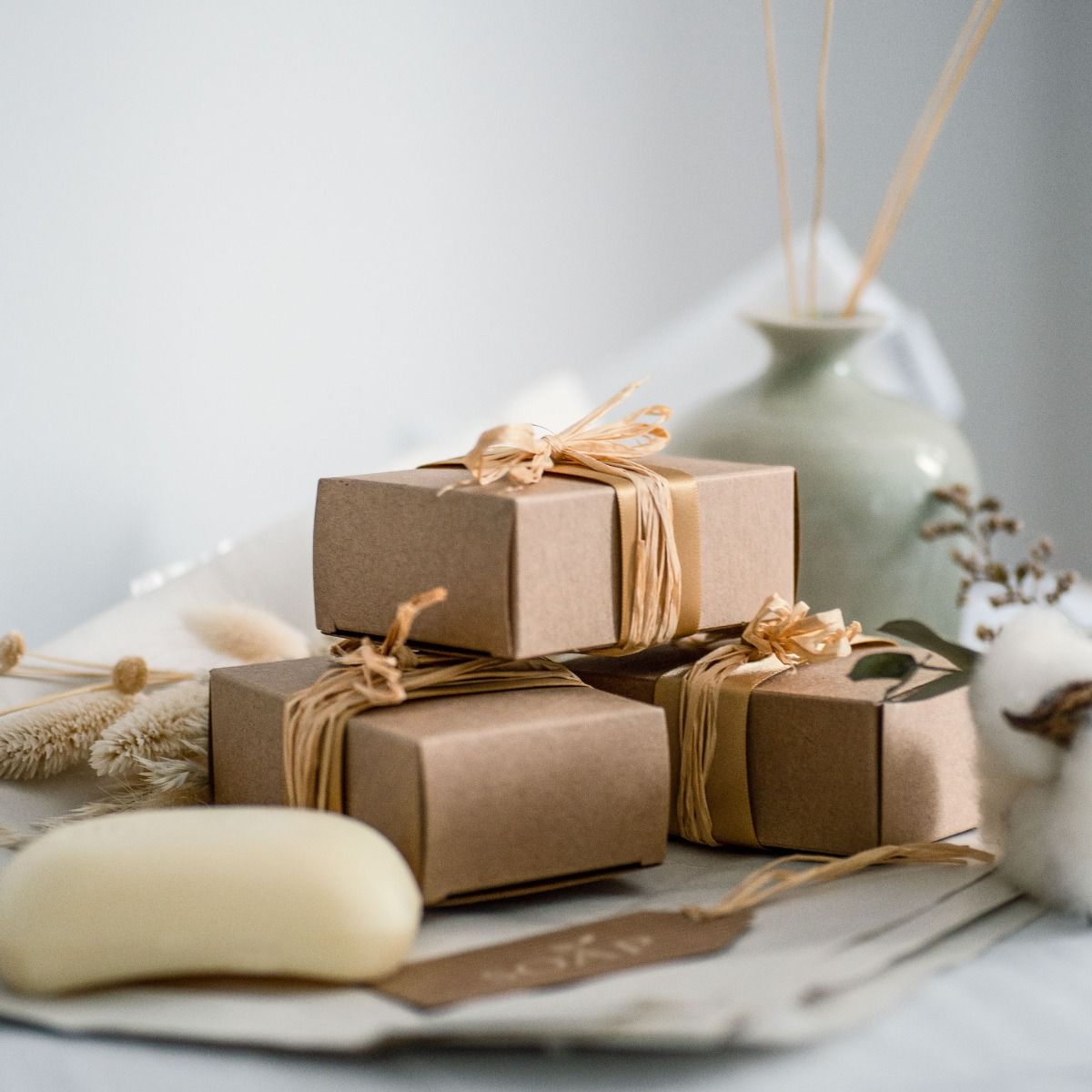 White hamper box with selection of gift boxes and gifts.